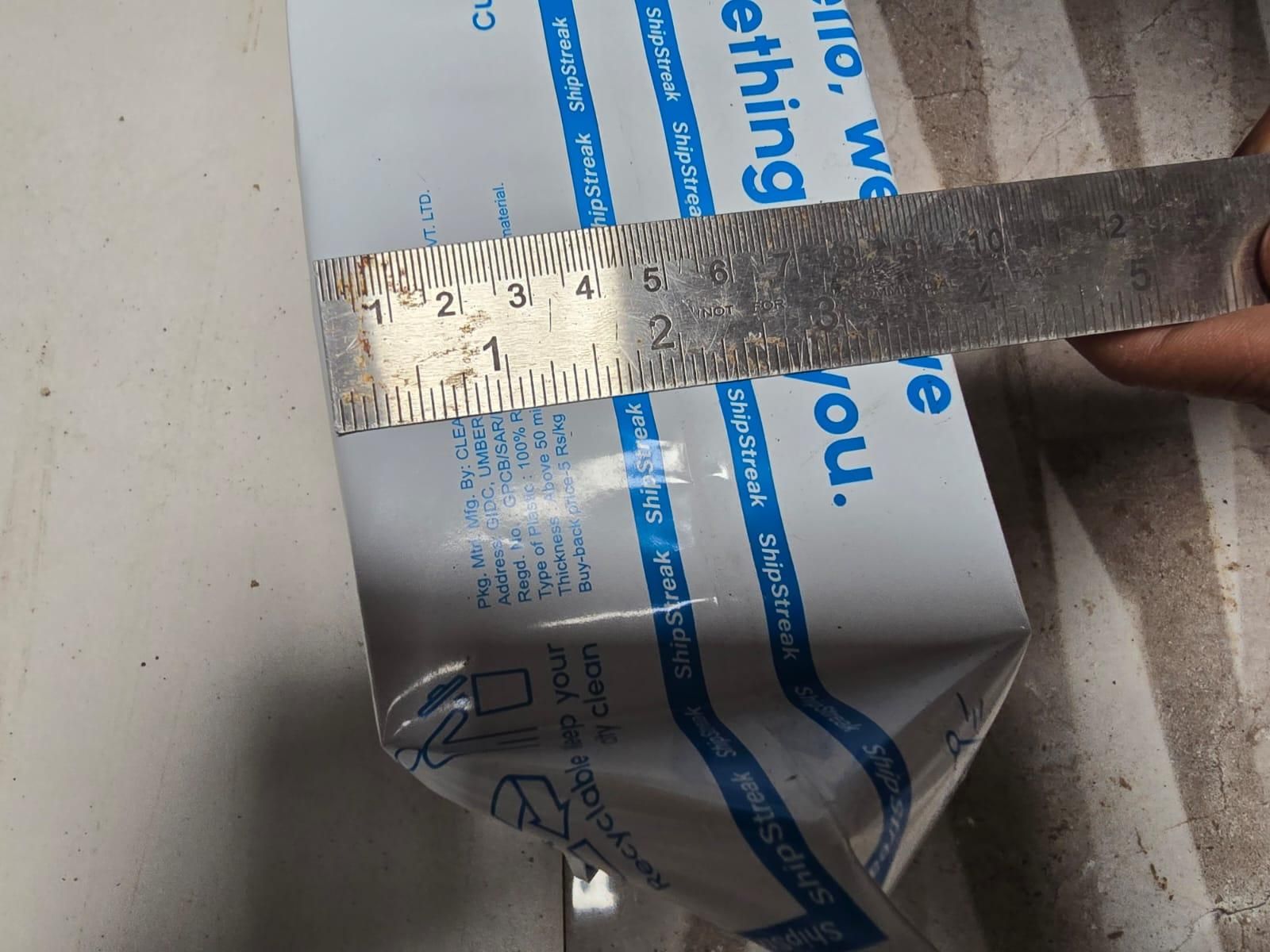 Measurement of a product using a ruler on a box with text