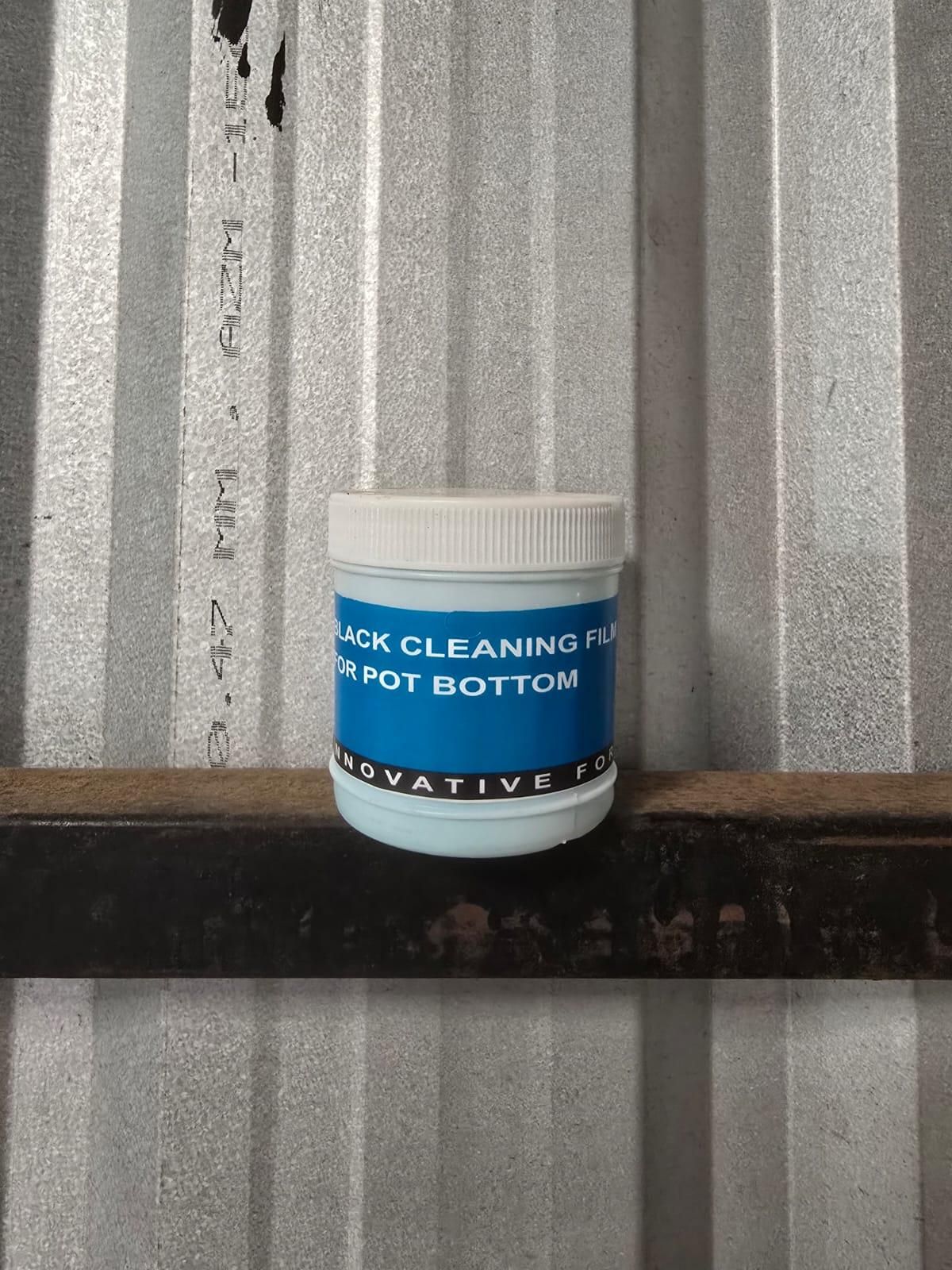 Jar of black cleaning film for pot bottom on a metal surface