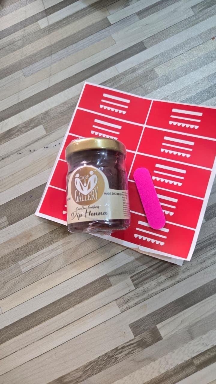 Jar of coffee on a red book with a pink bookmark on a wooden floor.