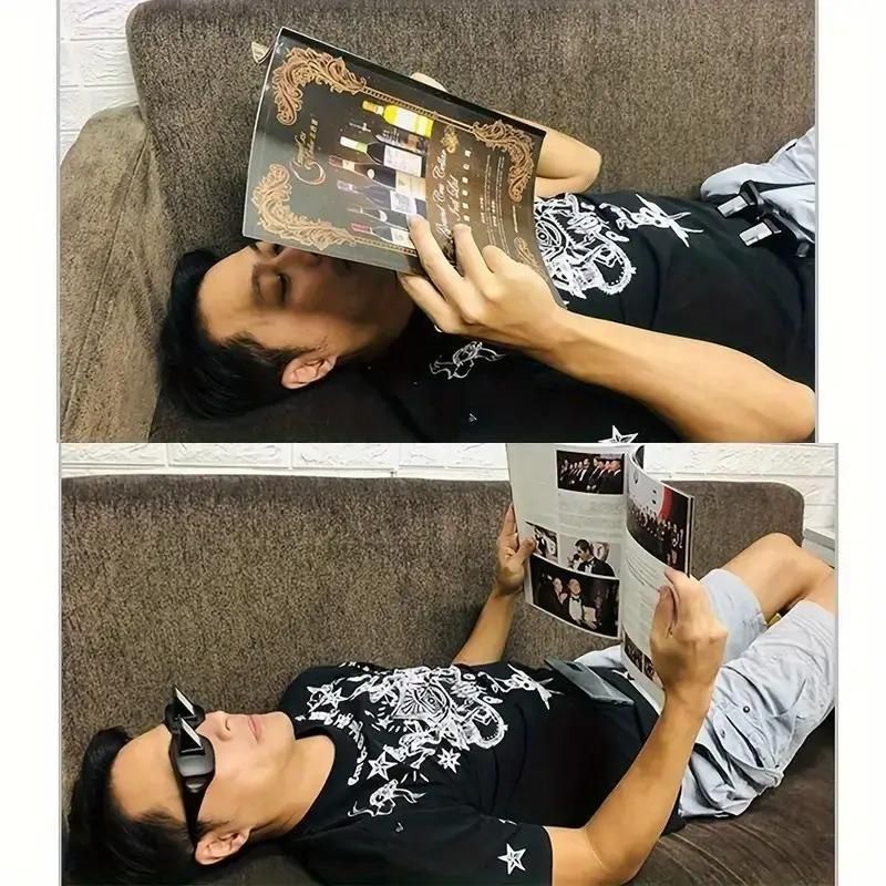 Person lying on a couch, holding and looking at a music album cover.
