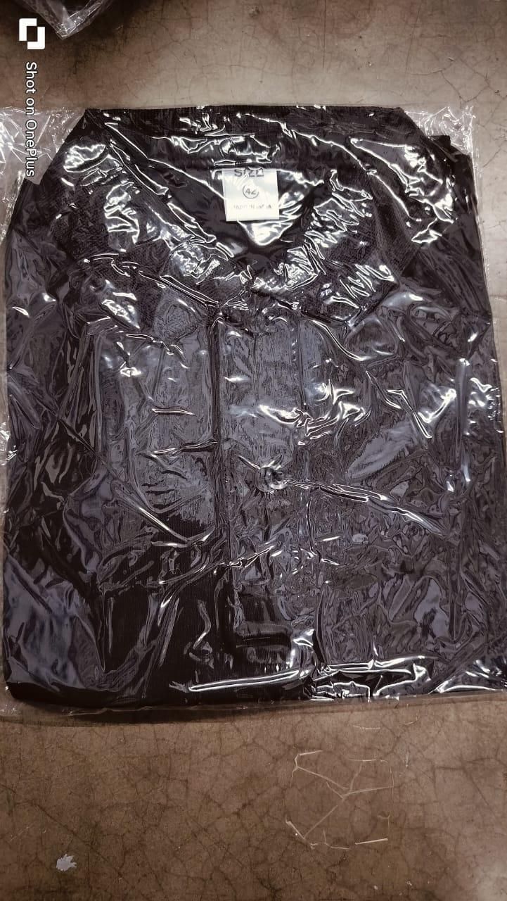 Black jacket in clear plastic wrap on a brown surface