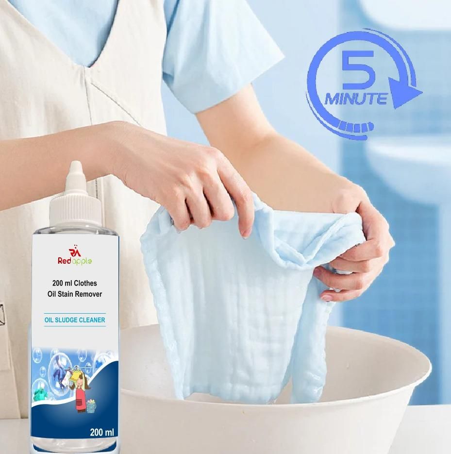 Person holding a bottle of oil stain remover and a piece of cloth over a sink.