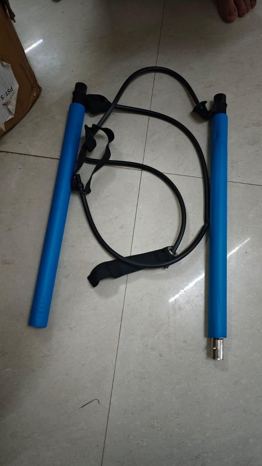Two blue poles with black cables on a tiled floor