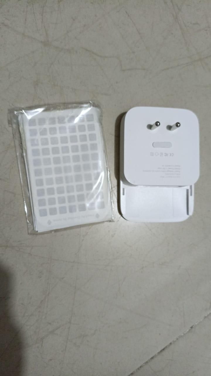 White electronic device with a grid pattern on a light gray surface
