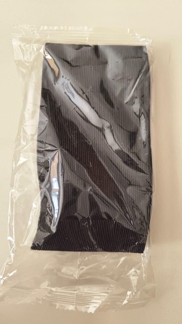 Black and gray patterned fabric in a clear plastic bag on a white background