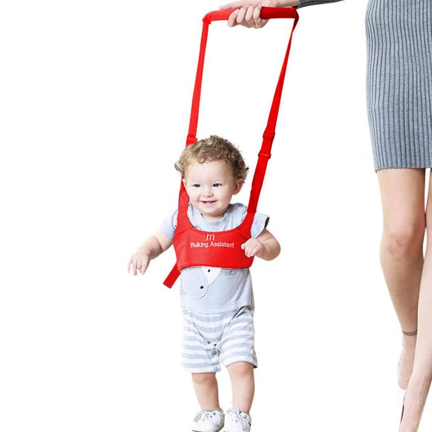 Baby walker assistant belt supporting a toddler during first walking steps